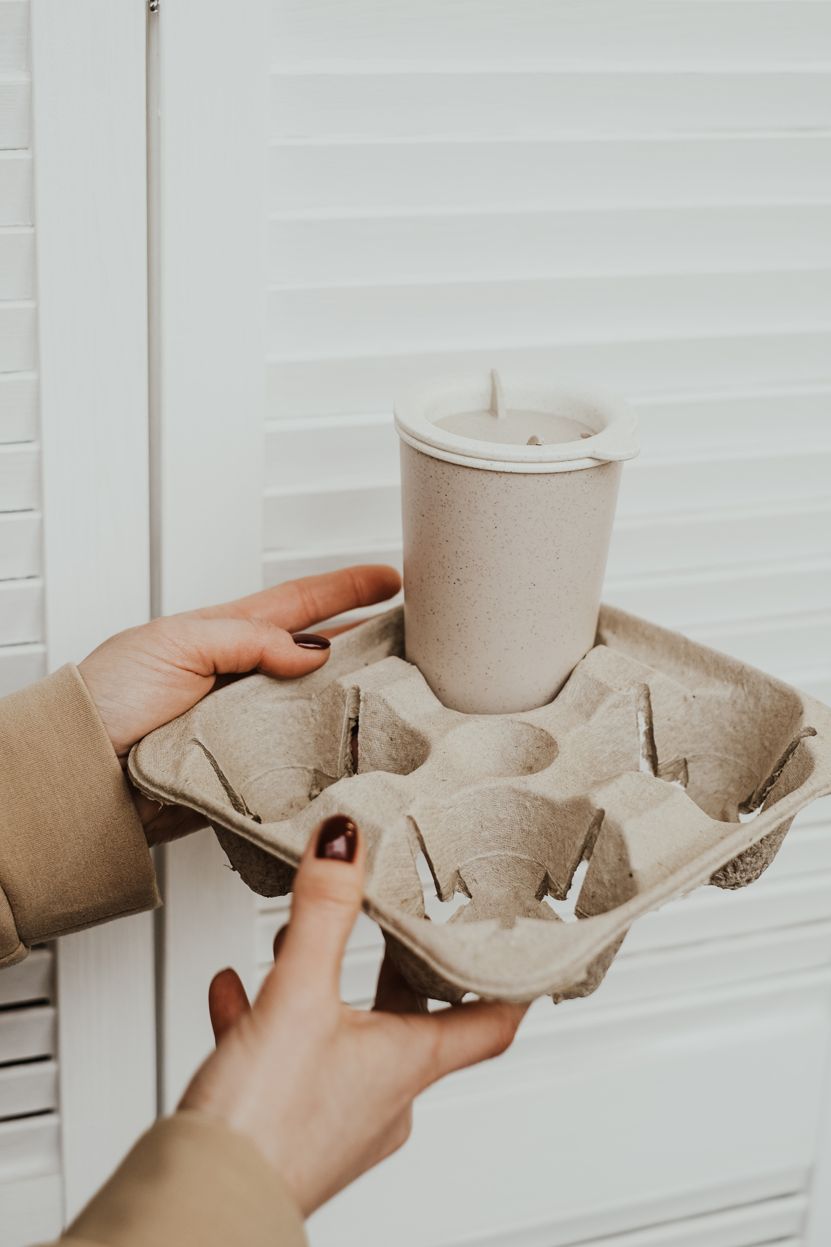 Hands Holding Paper Drink Tray with Reusable Tumbler